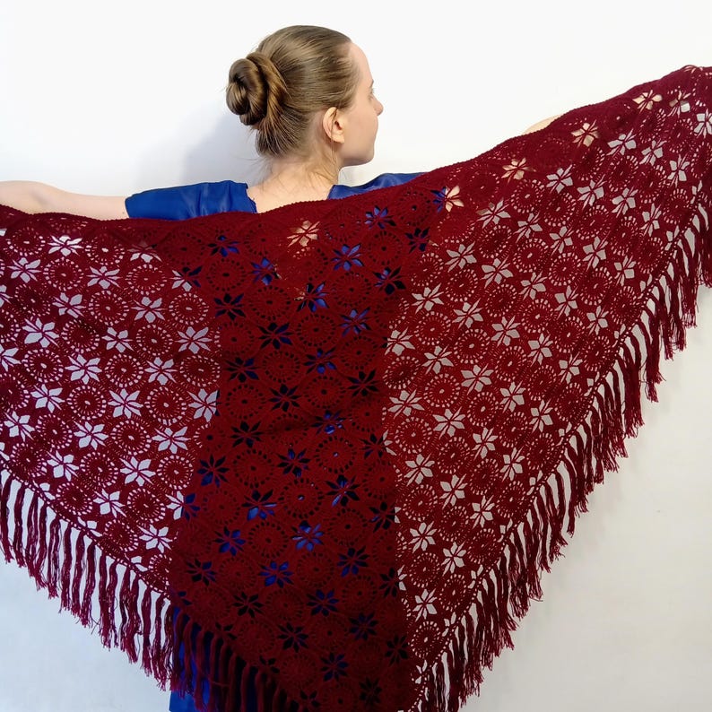 The model showcases a luxurious evening shawl with stunning details.