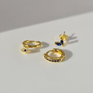 The Evil Eye 18k Gold Plated Stainless Steel Cubic Zirconia Matching Hoop and Stud 3pc Set.