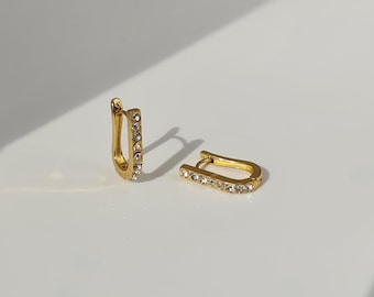 The Bobbie 18k Gold Plated Stainless Steel Cubic Zirconia Pave Crystal Oval Huggie Hoop Earrings.