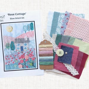 The instruction booklet, 7 colour threads, 15 coloured fabrics, base fabric, lace and 4 buttons you will receive