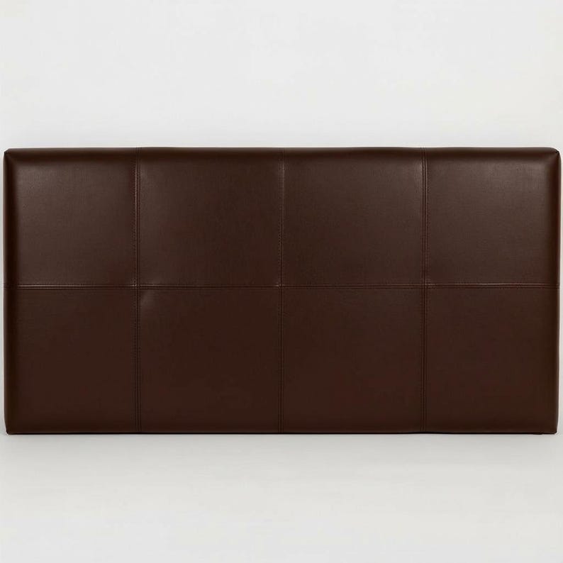 May include: A rectangular, dark brown leather headboard with a grid pattern. The headboard is divided into eight equal rectangular sections by stitched seams. The leather has a smooth, slightly glossy finish, and the overall design is simple and modern.