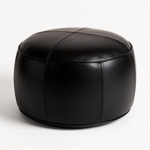 May include: A round, black ottoman with a stitched, cross-patterned top. The ottoman is made of a smooth, leather-like material and has a low profile. The sides are curved, and the base is a solid black.