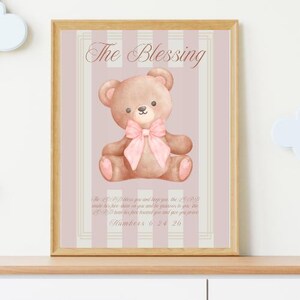 May include: A pink and white striped background with a brown teddy bear wearing a pink bow. The text "The Blessing" is at the top of the image. The text "The LORD bless you and keep you; the LORD make his face shine on you and be gracious to you; the LORD turn his face toward you and give you peace." is below the bear. The text "Numbers 6:24-26" is at the bottom of the image.