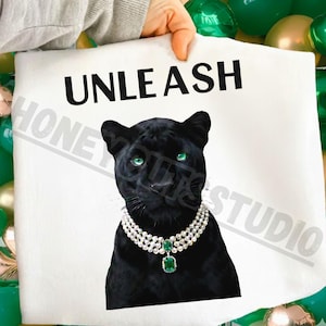 May include: A white ceramic mug with a black handle and the text "But First, Coffee" in a black, bold font. The mug is on a white surface. The mug is likely for hot beverages.