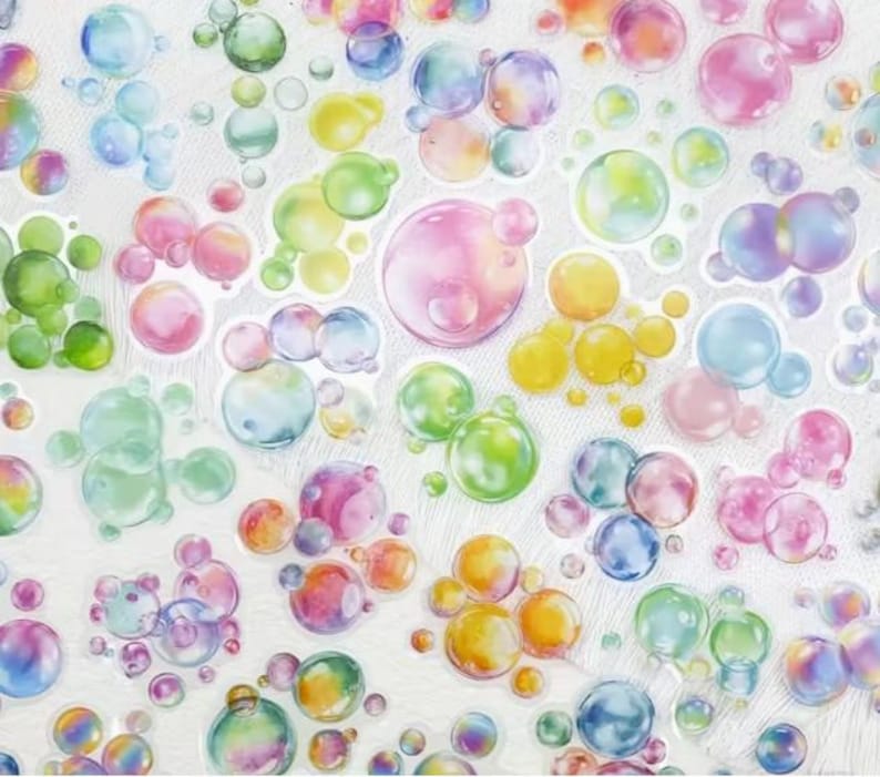 May include: A sheet of bubble stickers in a range of colours. The stickers have a watercolour effect, with shades of pink, blue, green, yellow, and orange. The bubbles are clustered together, creating a playful and whimsical design.