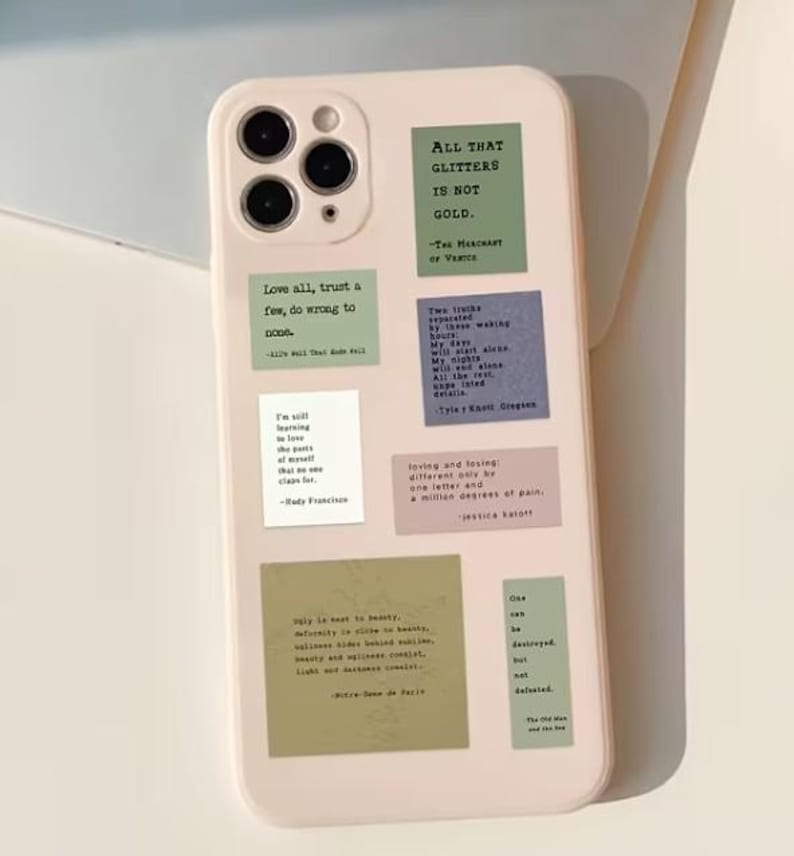 May include: A pale pink phone case adorned with several square stickers in different colours, each bearing quotes. These include phrases such as "All that glitters is not gold" and "Love all, trust a few, do wrong to good."