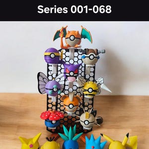 May include: A collection of spherical character balls from Series 001-068, featuring various creature-themed designs with distinct colours, wings, and ears. Some are mounted on a black hexagonal grid display stand, while others sit in front.