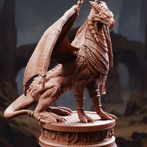 May include: A terracotta-colored dragon figurine standing on a circular base. The dragon features intricate scale textures, large wings, and Egyptian-style collar and leg bands. The base is decorated with carved symbols and figures in relief.