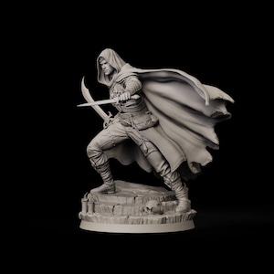 May include: A detailed figurine of a hooded figure in a dynamic pose, holding two curved blades. The figure is clad in a long cloak and detailed clothing, standing on a stone base with a skull. The overall color is a muted gray.