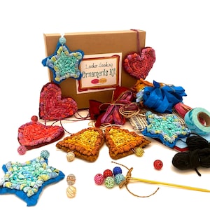 May include: A craft kit for making rug hooking ornaments. The kit includes a variety of colorful fabrics, yarn, beads, and a needle. The box is labeled "Locker Hooking Ornaments Kit".
