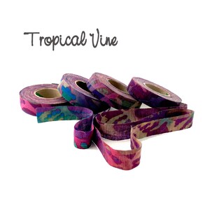 May include: Four spools of purple, pink, and blue patterned fabric ribbon with the text "Tropical Vine" above them.