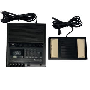 May include: A black Panasonic microcassette transcriber with a built-in speaker, volume and tone sliders, and a tape speed switch. It includes a separate black and beige foot pedal control unit with a backspace button and power cords.