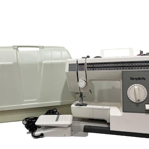 May include: A white Simplicity sewing machine with a grey control panel, a stitch selection dial, and a needle assembly. Included are a white hard-shell carrying case with a handle and a white foot pedal with a black power cord for operation.