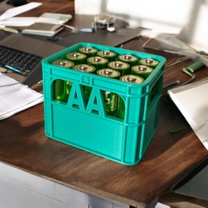 May include: A green plastic crate filled with AA batteries. The batteries are wrapped in green and white packaging with the text "Alkaline" printed on them.