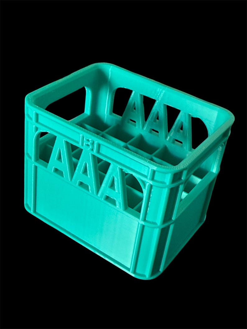 May include: A turquoise blue plastic crate with 12 compartments. The crate has a handle on the top and the number "131" printed on the side.