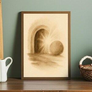 May include: Sepia-toned framed art print depicting an open tomb with a bright light emanating from within. A large, round stone rests nearby. The artwork is in a watercolor style, with soft edges and a warm color palette. The frame is a simple, dark wood.