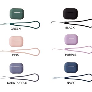 May include: AirPods case covers in various colors, including green, black, pink, purple, dark purple, and navy. Each case comes with a matching lanyard.