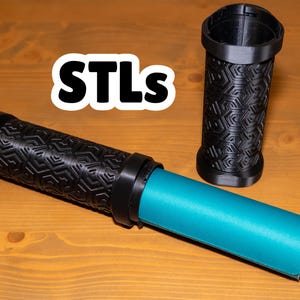 May include: Two black 3D printed tubes with a geometric pattern. One tube is empty and the other tube has a blue roll of paper inside. The text "STLs" is written in white on a black background.