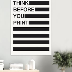 May include: A framed wall art print with the text "THINK BEFORE YOU PRINT" in bold black letters. The text is arranged vertically with black horizontal bars separating the words. The background is white.