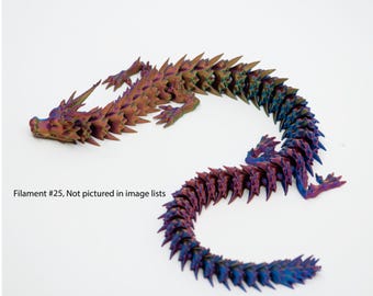 May include: A 3D printed dragon figurine with a iridescent finish. The dragon is curled up in a circle with its tail wrapped around its body. The dragon is made of a plastic filament and has a detailed design.