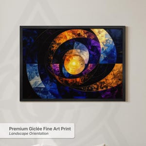 May include: A landscape orientation fine art print in a black frame featuring an abstract spiral composition. The design displays concentric circular patterns in vibrant shades of orange, deep blue, and purple, centred around a bright yellow core.