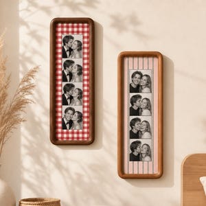 May include: Two vertical rectangular wooden frames containing photo strips. The left frame features a red and white gingham background with four black and white photos of a couple. The right frame has a light pink background with vertical stripes.