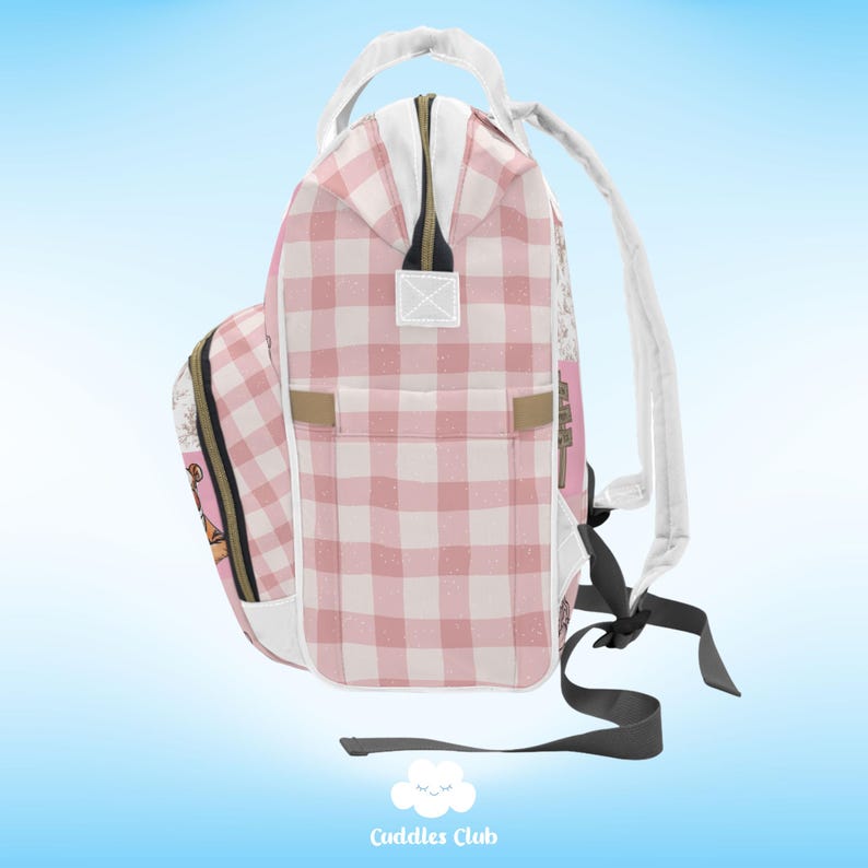 May include: Pink and white checkered backpack with a white zipper and a black strap. The backpack has a small pocket on the front with a floral design.