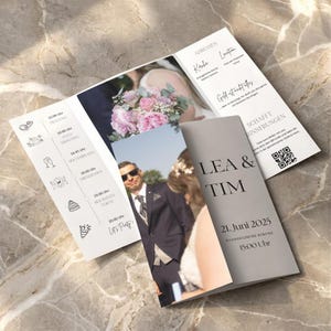 May include: A tri-fold wedding invitation with photographs and event details. The cover displays the names "LEA & TIM" and the date "21. Juni 2025". Inside, there are photos of the couple and a schedule of events, including "Foto Shooting" and "Hochzeits Torte".