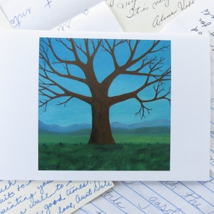 May include: A painting of a bare tree with a brown trunk and branches against a blue sky with green hills in the background.