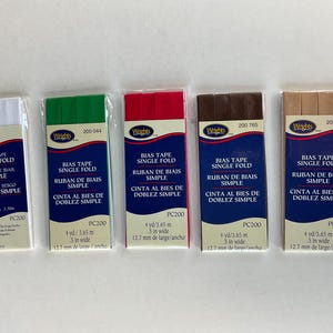 May include: Five rolls of single fold bias tape in white, green, red, brown, and beige. Each roll is labeled "Wrights Bias Tape Single Fold" and includes the length and width in yards, inches, meters, and millimeters.