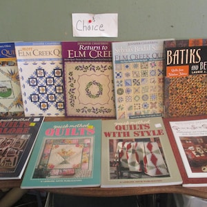 May include: A collection of quilting books with titles like "Elm Creek Quilts", "Batiks and Beyond", and "Quick Method Quilts".