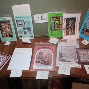 May include: A collection of 10 quilt patterns with various designs and titles, including "Summer Blooms", "Dream Spinners", and "Prairie Tulips".