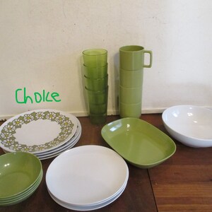 May include: A collection of vintage dishware, including plates, bowls, and cups. The set features white and green pieces, with some plates adorned with a daisy pattern. There are also green drinking glasses and mugs. The word "Choice" is written in green.