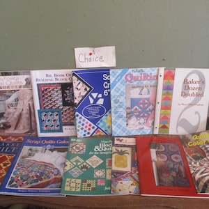 May include: A collection of nine quilting books with various titles, including "Miss Rosings Floral Quilts", "Big Book of Building Block Quilts", "Scrap Quilts Galore", "Nine Patch Block & Quilt for the Scraps", "Classic Quilt", "Baker's Dozen Doubled", "Plus's Quilting", "Quilting for Baby", and "Quilting Color Magic!".