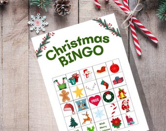 May include: A Christmas Bingo game sheet with a festive design. The sheet features a grid of Christmas-themed images and the words "Christmas BINGO" in green. Candy canes and pine branches with pinecones and a snowflake ornament are in the background.