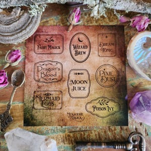 May include: A sheet of vintage-style labels with whimsical potion names such as "Fairy Magick", "Wizard Brew", "Dream Tonic", "Dragon's Blood", "Moon Juice", "Pixie Dust", "Mermaid Eggs", and "Poison Ivy". The labels are printed on a brown, textured background.