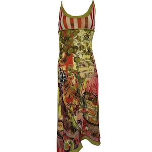 May include: A sleeveless midi dress featuring a red and white striped bodice and a green trim. The skirt displays a vibrant collage print of green grapes, musical notation, and red floral motifs with the text 'Sul mare' and 'luccica'.