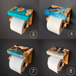 May include: Four wall-mounted toilet paper holders featuring a wooden shelf with embedded resin in turquoise, blue, and grey swirls. Each holder includes a wooden bracket, a black horizontal rod, and a roll of white toilet paper. Numbers 5, 6, 7, and 8 are visible.