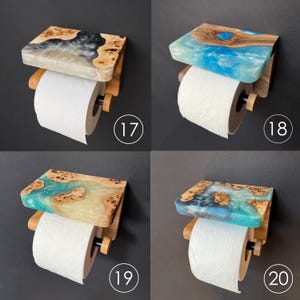 May include: Four wall-mounted toilet paper holders featuring a wooden shelf with embedded resin in various colors. Each holder includes a roll of white toilet paper and is labeled with a circular number tag from 17 to 20 in the bottom corner.