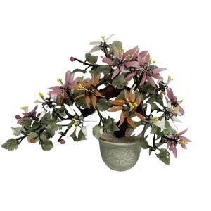 May include: A decorative bonsai tree with a ceramic pot. The tree features pink, orange, and white flowers with green leaves. The pot is light green with a floral design. The tree is a unique home decor item.