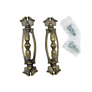May include: Two antique brass-toned drawer pulls with ornate detailing. Each pull features a central oval grip and decorative end pieces. Includes screws in a clear plastic bag for installation. Ideal for furniture restoration or adding vintage charm.