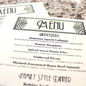 May include: A black and white menu with the word "MENU" in a decorative font at the top. The menu lists appetizers, including Butternut Squash Lollipops, Pomme Dauphine, Spiced Sweet Potato Fries, Flatbread Pizzas, and Mustard-Encrusted Roast Beef Sammie. The menu also includes a section for Family Style Dinner.