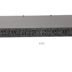 May include: A black rack-mounted audio mixer with multiple knobs and sliders. The mixer has a label that says "RANE".