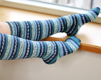 May include: A pair of blue and white striped knee-high socks. The socks are made of a soft, comfortable material and have a classic striped pattern.
