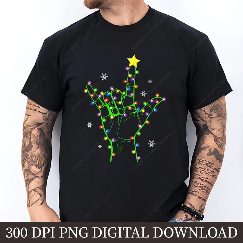 May include: Black t-shirt featuring a green hand in the "I love you" sign, decorated with colorful Christmas lights and a yellow star. White snowflakes are scattered around the hand. The text "300 DPI PNG DIGITAL DOWNLOAD" is at the bottom.