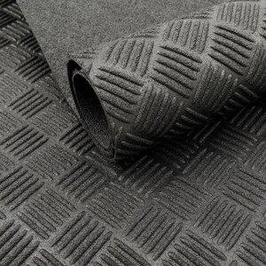 May include: A rolled-up, dark grey rubber mat featuring a diamond plate design. The mat has a textured surface with raised, diagonal lines, providing a non-slip texture. The rolled section shows the mat's thickness.
