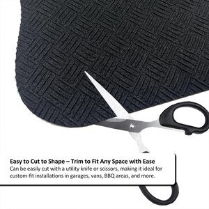 May include: A black textured mat with a woven pattern being cut with scissors. The scissors have black handles and silver blades. The image includes the text: "Easy to Cut to Shape - Trim to Fit Any Space with Ease."
