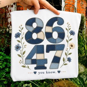 Puede incluir: Bolso tote blanco con los números 8647 en un diseño de patchwork de mezclilla. También hay detalles florales y la frase "you know". El bolso está sostenido por una mano.