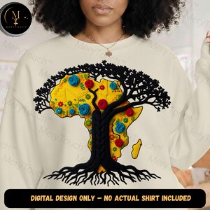May include: Cream-colored sweatshirt featuring a detailed graphic of the African continent in yellow, adorned with blue and red floral accents. A black tree design with roots and branches overlays the continent. The text reads: DIGITAL DESIGN ONLY - NO ACTUAL SHIRT INCLUDED.