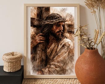 Op de afbeelding: Een ingelijste aquarelprint toont een man met lang haar, een baard en een doornenkroon, die een houten kruis draagt. Het kunstwerk gebruikt een warm kleurenpalet met bruine en beige tinten, wat een serene sfeer creëert. De afbeelding staat in een licht houten frame.